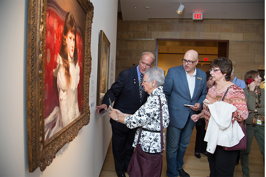 At left, Paul Young demonstrates how to use a smartphone to capture CRIS Access_ audible exhibit