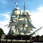 the morgan ship with multiple large white sales sitting in teh water
