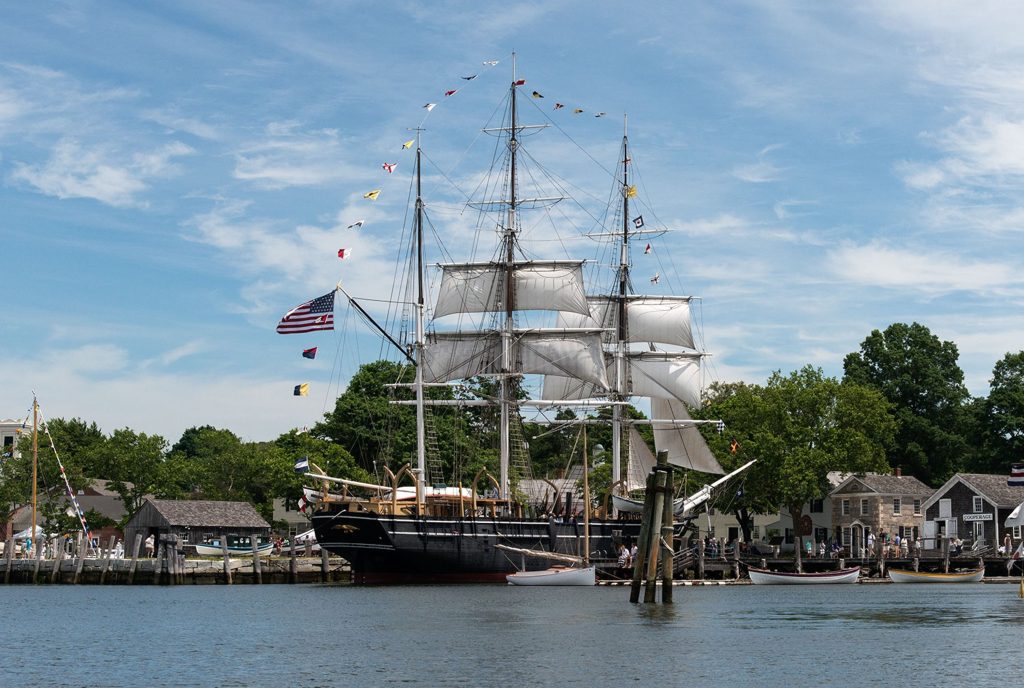A large antique ship in a harbor