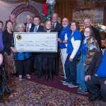 Members of the Bristol Lions Club, along with members from other Lions Clubs, present a donation to sponsor CRIS Radio_s audible exhibit intiiative