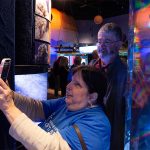 Rebecca and Richard Ireland using smartphone to scan qr code at Mystic Aquarium