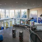 a picture of the entrance to the cetner with large photos of sea life on the walls and hanging dolphins