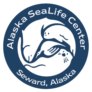 A blue and white circular logo for the alaska sealie center