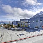 the Alaska SeaLife Center Facility - a building surrounded by snow capped mountains and water