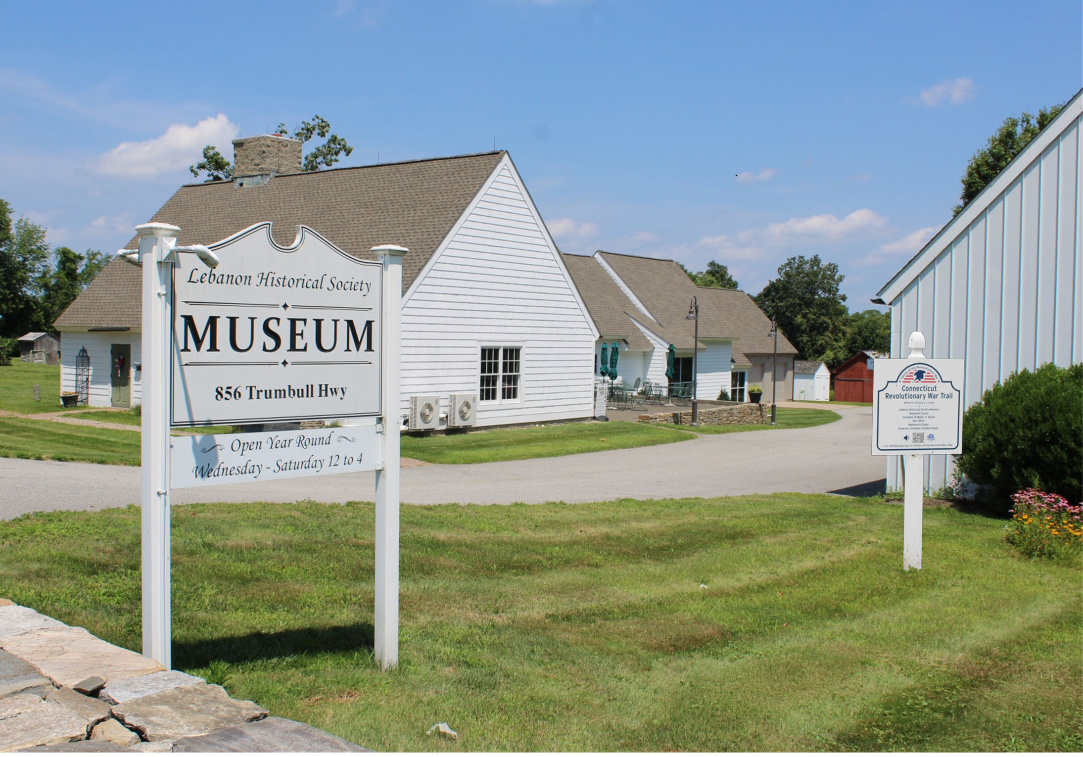 Lebanon Historical Society Museum “Exterior of the Lebanon Historical Society Museum in Lebanon, Connecticut. A large sign in front reads ‘Lebanon Historical Society Museum, 856 Trumbull Hwy,’ with white museum buildings and landscaped grounds in the background.”
